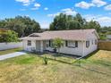 Charming single story home featuring a well-maintained lawn, fresh paint, and a decorative front door at 2317 10Th St, St Cloud, FL 34769