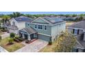 Aerial view of a two-story home with solar panels and a well-maintained lawn at 238 Granada Ave, Davenport, FL 33837