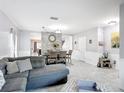 Open-concept living room featuring stylish furniture and an adjacent dining area at 238 Granada Ave, Davenport, FL 33837