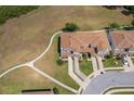 Overhead view of townhomes showing lawn, landscaping, and sidewalks at 2462 Hassonite St, Kissimmee, FL 34744