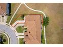 Property lines shown in red of this townhome with sidewalks, roof, and lawns at 2462 Hassonite St, Kissimmee, FL 34744