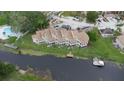 Aerial view of waterfront property featuring a private dock and boat lift with lush greenery at 2662 Emerald Lake Ct, Kissimmee, FL 34744