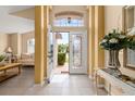 Bright foyer with tile flooring, decorative columns, and a view into the formal living area at 301 Wingdale Way, Davenport, FL 33897