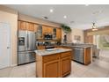 Modern kitchen with stainless steel appliances, granite countertops, and a center island at 301 Wingdale Way, Davenport, FL 33897