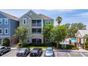 Exterior of a multi-story condo building with a community pool nearby and assigned parking at 3344 Corona Village Way # 207, Orlando, FL 32835