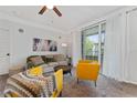 Cozy living room boasts neutral tones, comfortable seating, and sliding glass doors at 3344 Corona Village Way # 207, Orlando, FL 32835