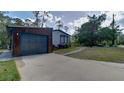 Exterior features a modern home with a gray two-car garage and a concrete driveway at 3669 General Marshall Rd, Daytona Beach, FL 32124