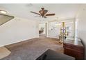 Spacious living room features neutral walls, carpet and a modern ceiling fan at 410 Canna Dr, Davenport, FL 33897
