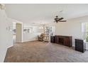 Spacious living room features neutral walls, carpet and a modern ceiling fan at 410 Canna Dr, Davenport, FL 33897