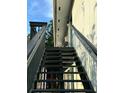 Exterior stairs lead to the second-story balcony at 4820 Conway Rd # 130, Orlando, FL 32812