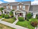 Aerial view of a well-maintained townhome community with manicured lawns and sidewalks at 4909 Terrapin Blvd, St Cloud, FL 34771