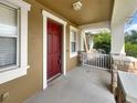 Inviting front porch with stone pillars and a red door, perfect for relaxing at 4909 Terrapin Blvd, St Cloud, FL 34771