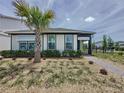 Charming single-story home showcases a lush, landscaped yard and inviting exterior, with a palm tree at 6514 Barnstorm Way, St Cloud, FL 34771
