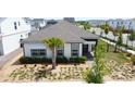 Inviting single-story home with manicured front yard, enhanced by a lovely palm tree and charming walkway at 6514 Barnstorm Way, St Cloud, FL 34771