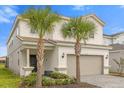 Charming two-story home with a two-car garage, palm trees, and manicured landscaping at 7211 Oakmoss Loop, Davenport, FL 33837