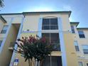 Behold this sunny multi-story exterior showing two private screened patios perfect for enjoying the weather! at 8809 Dunes Ct # 201, Kissimmee, FL 34747