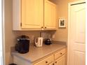 Kitchen counter area including cabinets, blender, coffee machine, and water heater at 8809 Dunes Ct # 201, Kissimmee, FL 34747