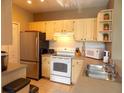 Bright kitchen featuring stainless steel appliances and a double sink at 8809 Dunes Ct # 201, Kissimmee, FL 34747