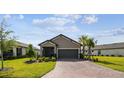 Charming front exterior view of home with well-maintained lawn and colorful landscaping at 1014 Umbria Dr, Kissimmee, FL 34759