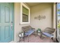 Cozy front porch featuring stylish outdoor furniture on brick pavers, creating a welcoming entrance to the home at 1014 Umbria Dr, Kissimmee, FL 34759