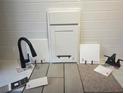 Image displays the material selections that include a tile backsplash, flooring, cabinets, faucet, and countertop at 1019 Cloud Ridge Ct, Mount Dora, FL 32757