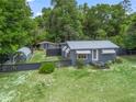 Charming single-story home with a metal roof, fenced yard, and additional outbuildings at 1081 Se 174Th Ter, Silver Springs, FL 34488