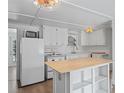 Functional kitchen featuring modern appliances, white cabinets, and an island at 1081 Se 174Th Ter, Silver Springs, FL 34488