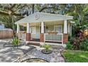 Charming home featuring a cozy front porch with brick accents, flower boxes and a landscaped front yard at 1104 E Anderson St, Orlando, FL 32801