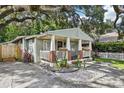Charming home featuring a cozy front porch with brick accents, flower boxes and a landscaped front yard at 1104 E Anderson St, Orlando, FL 32801