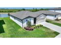 Well-maintained one-story home with a two-car garage, fresh landscaping, and a lush green lawn at 1158 Oak Valley Dr, Auburndale, FL 33823