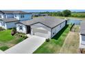 Charming one-story home with a two-car garage, a well-kept lawn, and exterior stone accents at 1158 Oak Valley Dr, Auburndale, FL 33823