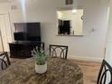 Cozy dining area next to living room featuring marble-top table, adjacent to a pass-through to the kitchen at 13226 Galicia St # 103, Orlando, FL 32824