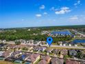 Neighborhood aerial view showcasing the home's location with a lake and the community at 1416 Lexington Ave, Davenport, FL 33837