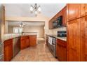 Well-equipped kitchen with cherry cabinets, stainless appliances, and granite countertops at 153 Pine Isle Dr, Sanford, FL 32773