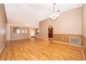 Spacious living room featuring hardwood floors, neutral walls, and a chandelier at 153 Pine Isle Dr, Sanford, FL 32773