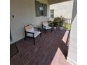 Covered front porch featuring brick flooring and cozy chairs for relaxing at 16043 Scarpetta St, Winter Garden, FL 34787