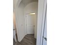 Hallway with tile flooring, arched doorway, and white doors at 16043 Scarpetta St, Winter Garden, FL 34787