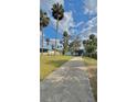Charming single-story home with a covered front porch and mature landscaping under a blue sky at 2350 Valley Dr, Apopka, FL 32703