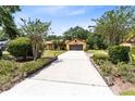 Home featuring a long driveway with mature landscaping at 2560 Greenwood Dr, Kissimmee, FL 34744