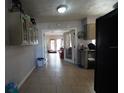 Kitchen with tile floors leading to a living area; great for entertaining or Gathering gatherings at 26 College Dr, Babson Park, FL 33827