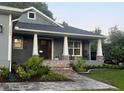 Inviting front porch and walkway with stone accents and beautifully landscaped yard at 2943 Annalee Rd, St Cloud, FL 34771