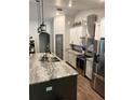 Bright kitchen featuring stainless steel appliances and gray granite countertops at 2943 Annalee Rd, St Cloud, FL 34771