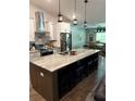 Modern kitchen featuring stainless steel appliances, island with seating, and pendant lighting at 2943 Annalee Rd, St Cloud, FL 34771