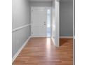 Hallway featuring laminate flooring, neutral paint, and white trim at 301 Lake Ned Rd, Winter Haven, FL 33884