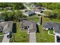 Aerial view of home featuring solar panels, fenced yard, and green landscaping at 341 Gardenia Ct, Kissimmee, FL 34759
