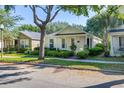 Lovely home with a manicured lawn and inviting curb appeal, complemented by mature trees and a sunny sky at 6821 Cultivation Way, Winter Garden, FL 34787
