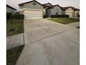 Attractive home with a well-manicured lawn, a spacious driveway, and a two-car garage at 748 Citrus Isle Dr, Davenport, FL 33837
