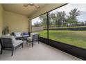 Relaxing screened-in patio, perfect for enjoying the outdoors with comfortable seating and serene backyard views at 9056 Wildflower Ln, Kissimmee, FL 34747