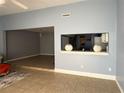 Bright living room with tile floors, open layout to the kitchen, and neutral paint color at 914 Caribbean Dr, Davenport, FL 33897