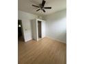 Bright bedroom features modern wood flooring, closet, and ceiling fan at 924 Ferndell Rd, Orlando, FL 32808